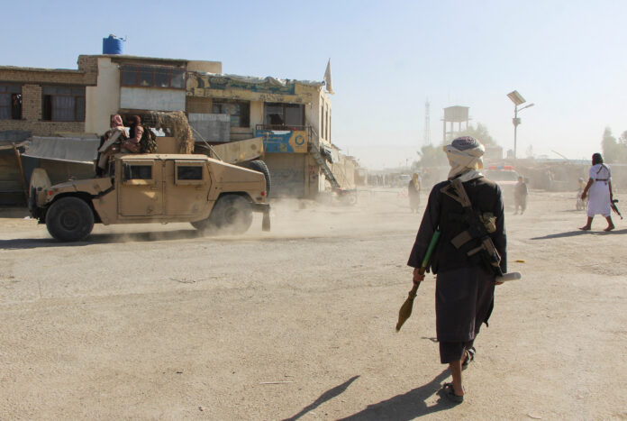 Afghan Taliban fighters patrol near the Afghanistan-Pakistan border in Spin Boldak, Kandahar Province, following exchanges of fire between Pakistani and Afghan forces