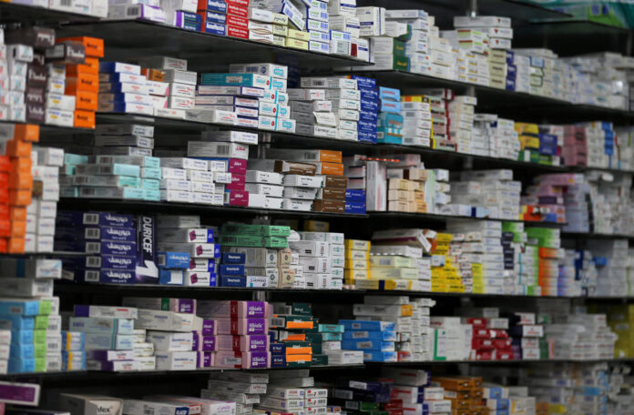 Medicine are arranged on a shelf inside in a pharmacy in Cairo