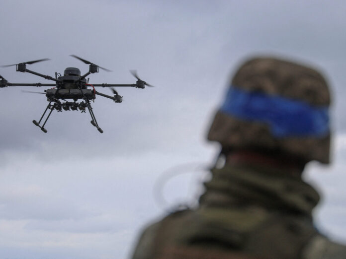 FILE PHOTO: Ukrainian serviceman looks at a heavy drone during its flight near a front line in Donetsk region